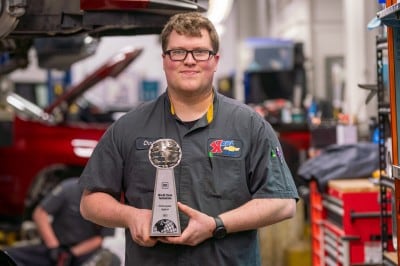 Karl Chevrolet GM World Class Technician holding 2023 World Class Technician award in the Ankeny service center