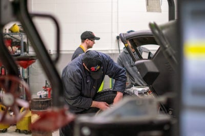 Karl Chevrolet technician balancing a tire at the Ankeny Certified Service Main Drive